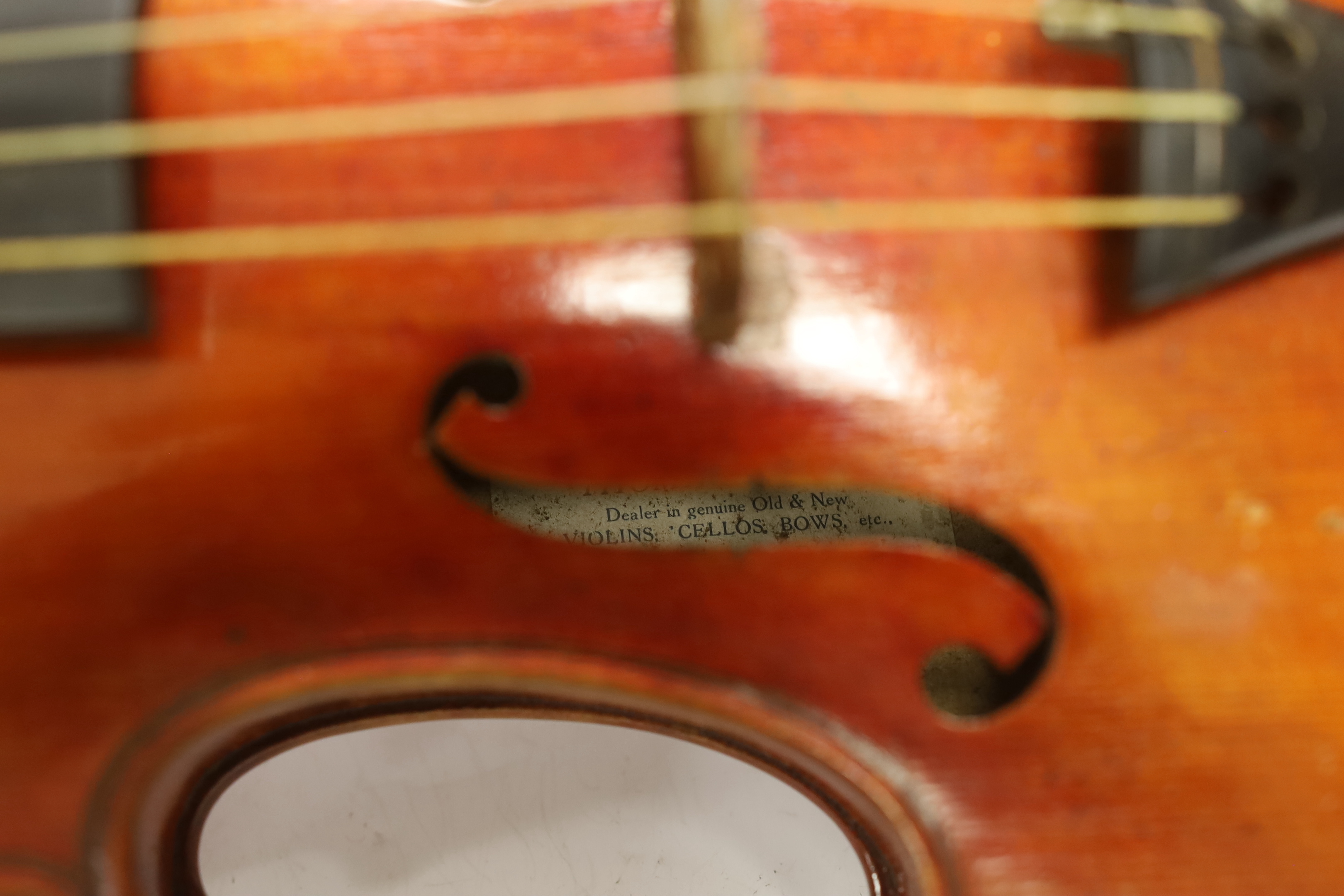 A French violin, c. 1900, with a retailer’s label inside the body for Thomas Smith, 183 Sherlock St. Birmingham, cased with a bow, body 35.5cm